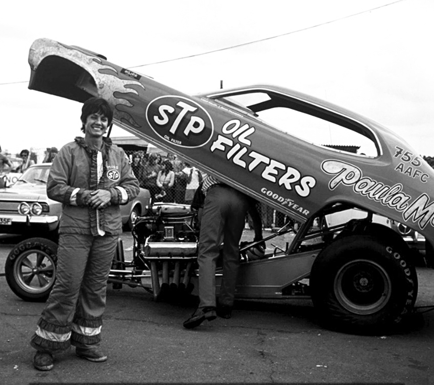 paula murphy posing with stp car
