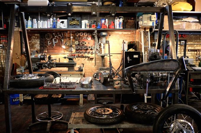 motorcycle parts strewn around a garage