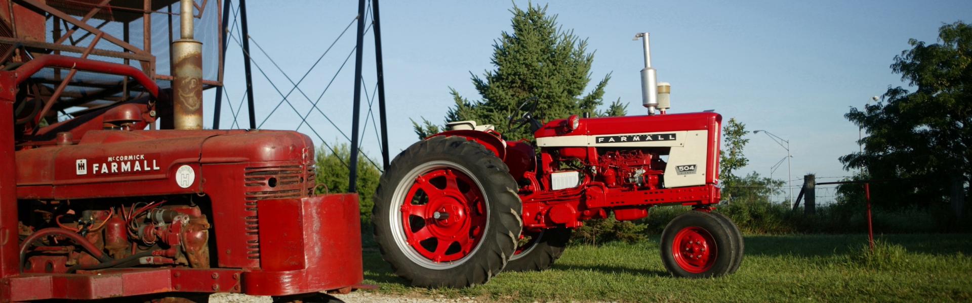 tractor parked under the farmall-land sign