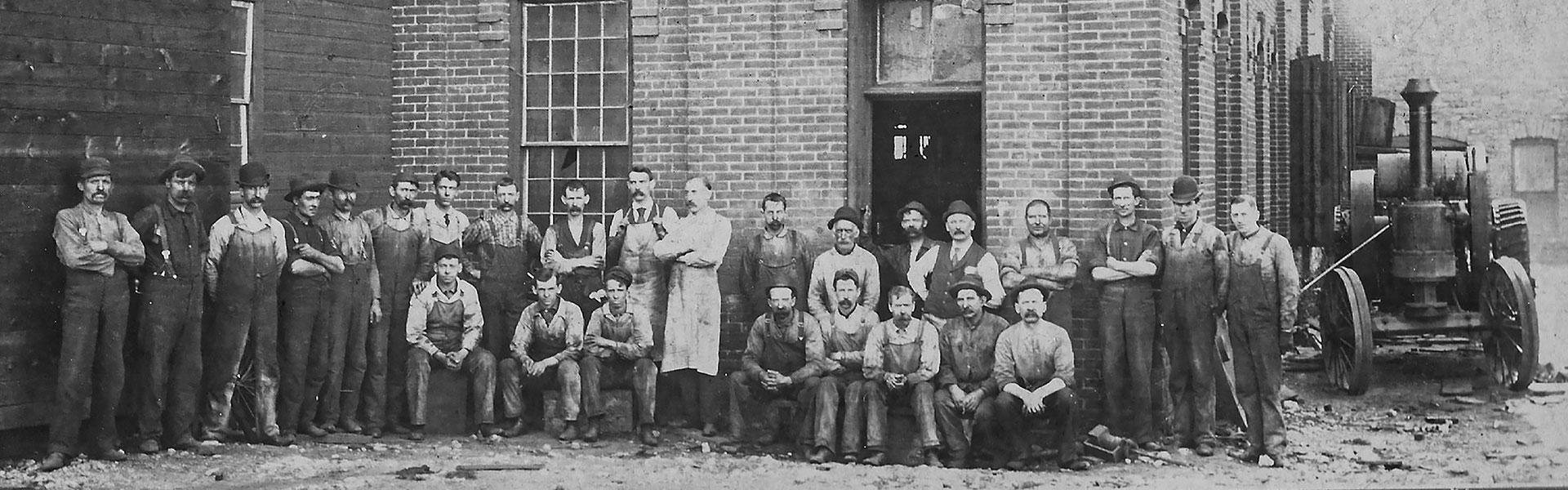 group in front of charter engine co.